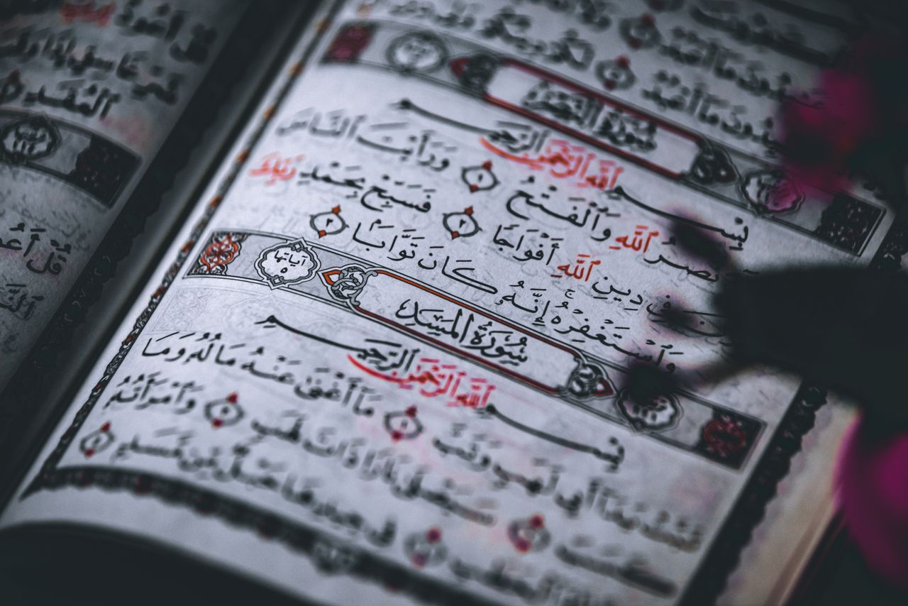 Close-up of Quranic text showcasing intricate Arabic calligraphy and traditional illumination.